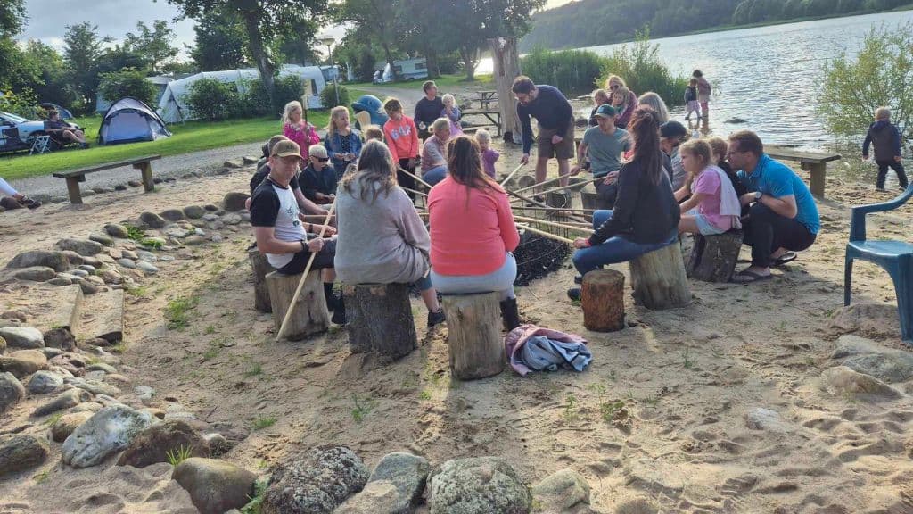 Fårup Sø Camping - Twist bread baking over the fire at the edge of the lake