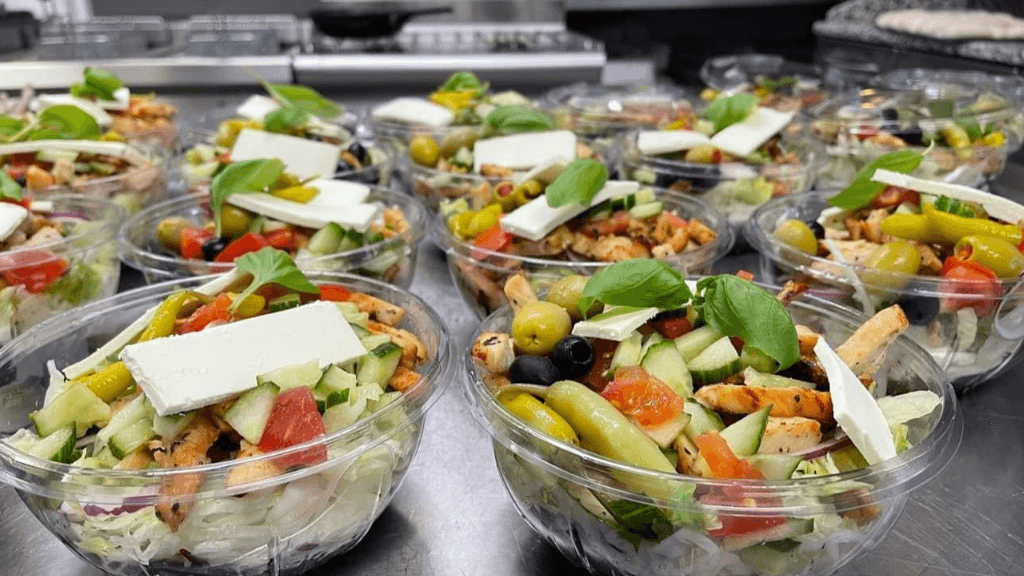 Mixed Greek Salad in a glas bowl with feta